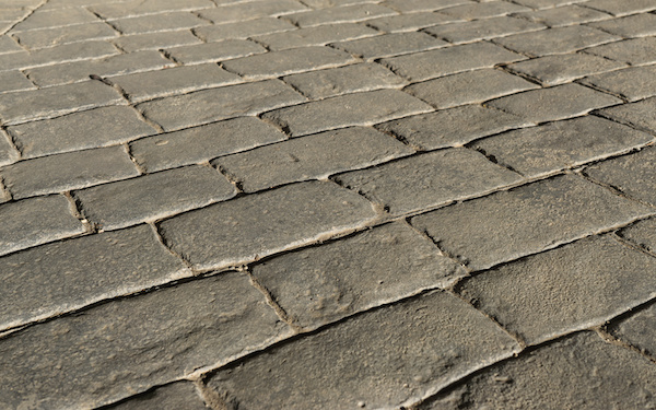 Stamped concrete pavement outdoor, mimics cobblestones pattern, decorative appearance colors and textures of paving cobble stone